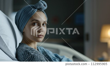 Young cancer woman lying in hospital bed 112995905