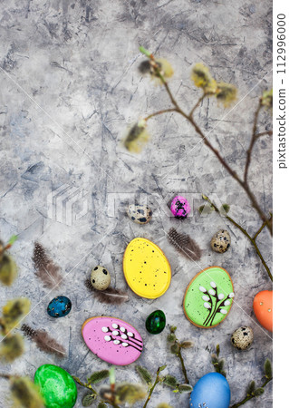 Delicious Easter cookies and painted eggs on gray background, top view Delicious Easter cookies and painted eggs on gray background, top view 112996000