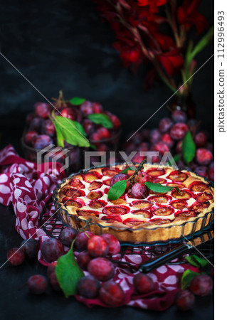 Fresh homemade plum tart or cake on dark background 112996493