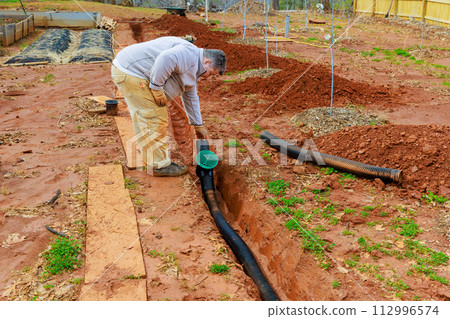 Installation of an underground drainage system to allow rainwater stormwater to exit 112996574