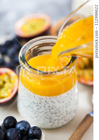 Chia pudding with  yogurt, mango and passion fruit, making process 112996622
