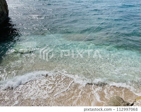 Rocky beach and crystal turquoise water of Ionian Sea in Albania. 112997068