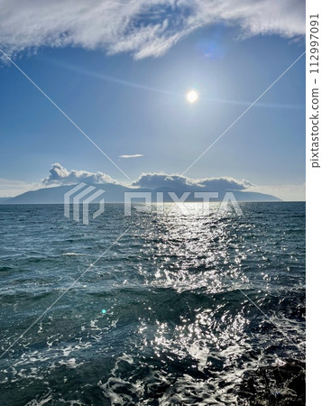 Scenic sunset over Ioninan sea in Vlore Albania. Vertical photo. Scenic sunset over Ioninan sea in Vlore Albania. Vertical photo. 112997091