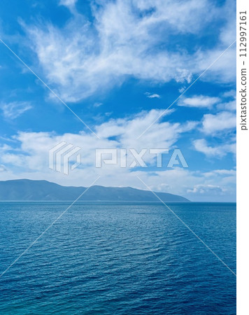 Scenic sunset over Ioninan sea in Vlore Albania. Vertical photo.  112997161