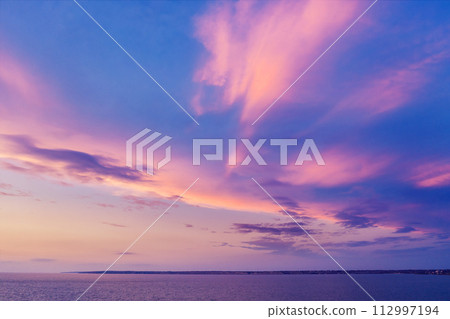 Colorful cloudy sky above the sea during sunset 112997194