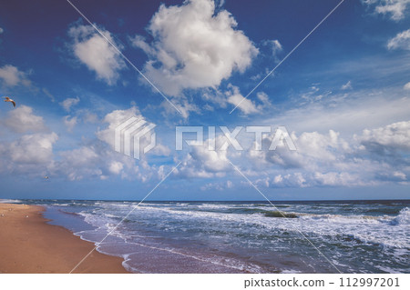 Seascape on a sunny day. Stormy sea with a beautiful cloudy sky. Nature landscape Seascape on a sunny day. Stormy sea with a beautiful cloudy sky. Nature landscape 112997201