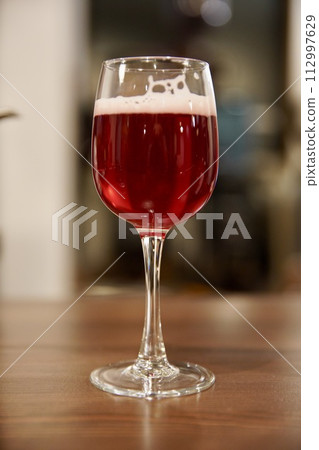 red beer in wine glass 112997629