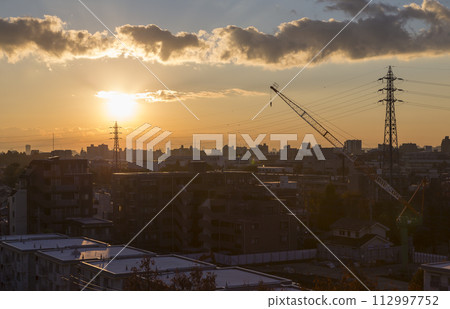 Sunrise over the residential area, sunrise, morning over the residential area, early morning, morning glow, morning sun, sun 112997752