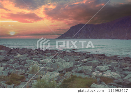 Rocky seashore with cloudy sky. Wilderness. Beautiful nature of Norway. Lofoten islands Rocky seashore with cloudy sky. Wilderness. Beautiful nature of Norway. Lofoten islands 112998427