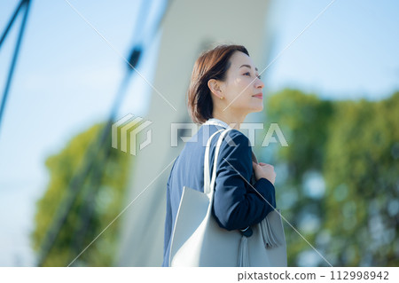 Business woman looking up at the sky 112998942