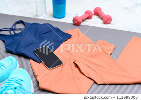 Item set for muscle training girls who are starting to exercise are lined up on a rug on the floor Women's wear Background material Background 112999000