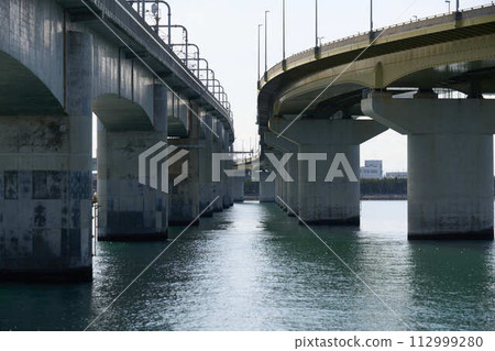 Piers of two bridges lined up on the sea Piers of two bridges lined up on the sea 112999280