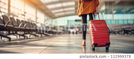 Woman walking in airport with baggage. Tourism concept. 112999378