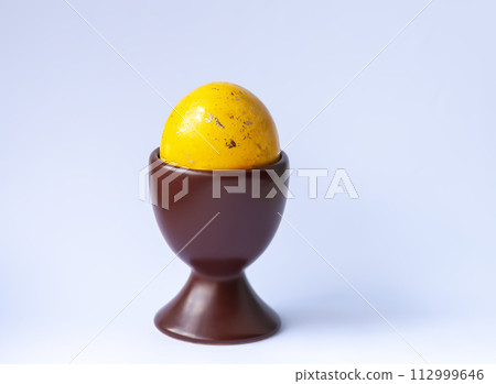 Colored egg. Traditional Easter food and decoration. 112999646
