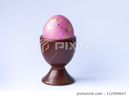 Colored egg. Traditional Easter food and decoration. 112999647