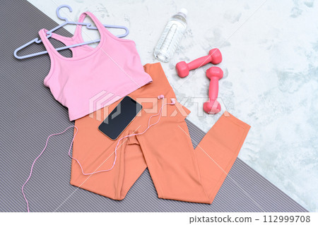 Item set for muscle training girls who are starting to exercise are lined up on a rug on the floor Women's wear Background material Background Item set for muscle training girls who are starting to exercise are lined up on a rug on the floor Women's wear Background material Background 112999708
