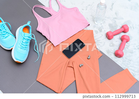 Item set for muscle training girls who are starting to exercise are lined up on a rug on the floor Women's wear Background material Background 112999713