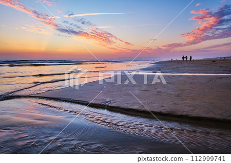 Atlantic ocean sunset with surging waves at Fonte da Telha beach, Portugal 112999741