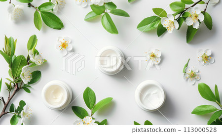 Elegant beauty creams amidst blooming cherry branches, spring skincare theme, white background. 113000528