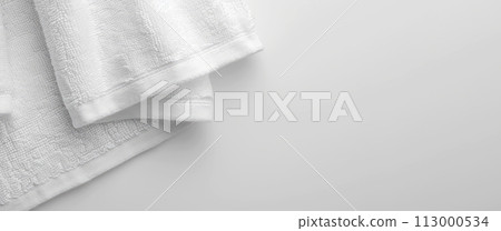 Close-up of a White Textured Towel on a Smooth Surface. Copy space Close-up of a White Textured Towel on a Smooth Surface. Copy space 113000534