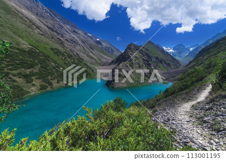 Lake with clear blue water in mountains under sky with clouds in summer 113001195