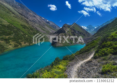 Lake with blue clear clear water in mountains in summer. Koksai Ainakol Lake in Tien Shan Mountains in Asia in Kazakhstan Lake with blue clear clear water in mountains in summer. Koksai Ainakol Lake in Tien Shan Mountains in Asia in Kazakhstan 113001212