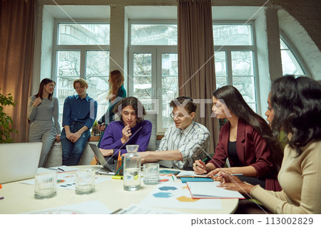 Young boys and girls, student meeting in university library for studying and doing projects together. 113002829