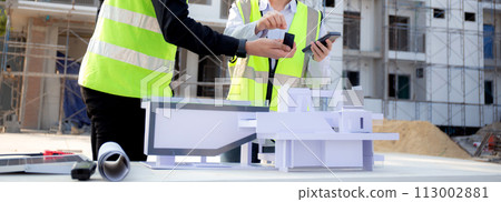 Team young engineer or architect meeting and planning installation solar panel at construction site. 113002881