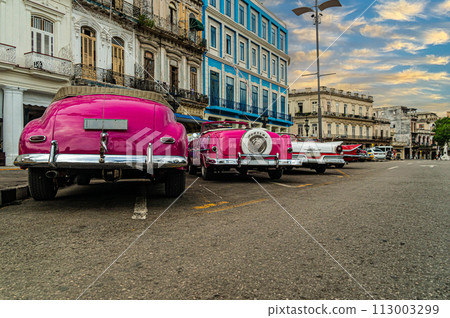 Bright retro cars on Havana street near the hotel. Cuba. Gran Teatro de La Habana, Low angle. 113003299