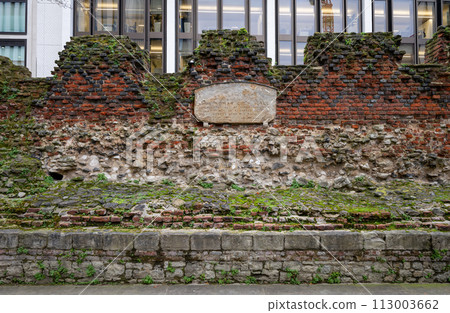 London, UK: Part of the ancient city wall of London. This is a medieval wall with the Roman fort wall at its base and topped with a brick parapet added in 1477. Landscape orientation. London, UK: Part of the ancient city wall of London. This is a medieval wall with the Roman fort wall at its base and topped with a brick parapet added in 1477. Landscape orientation. 113003662