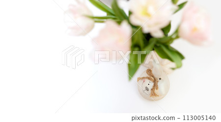 bouquet of tulips and Easter bunny on white table. copy space 113005140