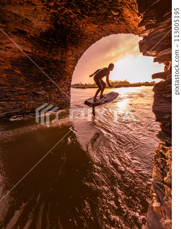 Hydrofoil rider gliding over the water 113005195