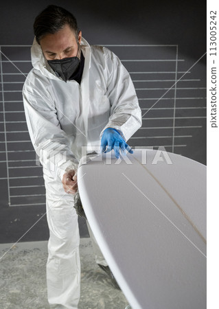 Shaper working on surf board 113005242