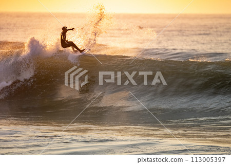 Young surfer enjoying waves Young surfer enjoying waves 113005397