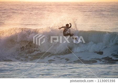 Sporty boy riding his surf board Sporty boy riding his surf board 113005398