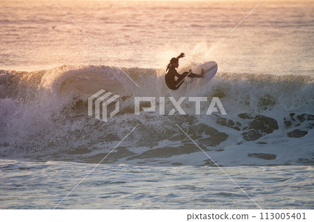 Sporty boy riding his surf board Sporty boy riding his surf board 113005401