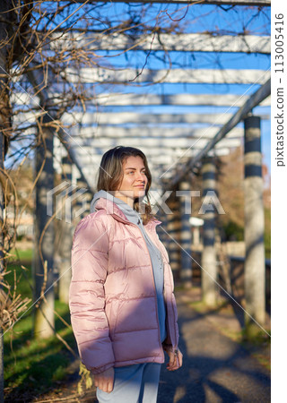Winter Fun in Bitigheim-Bissingen: Beautiful Girl in Pink Jacket Amidst Half-Timbered Charm. a lovely girl in a pink winter jacket standing in the archway of the historic town of Bitigheim-Bissingen Winter Fun in Bitigheim-Bissingen: Beautiful Girl in Pink Jacket Amidst Half-Timbered Charm. a lovely girl in a pink winter jacket standing in the archway of the historic town of Bitigheim-Bissingen 113005416
