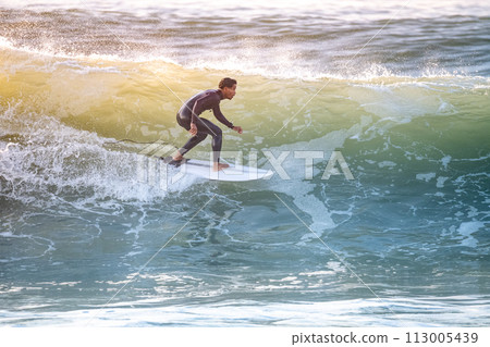 Young surfer enjoying waves Young surfer enjoying waves 113005439
