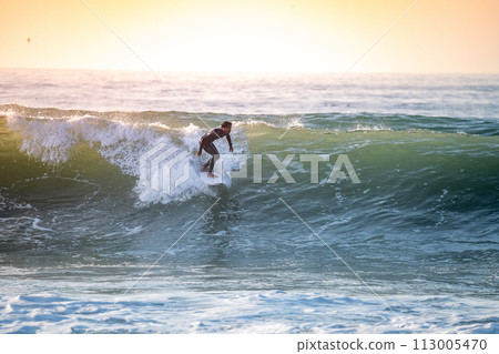 Sporty boy riding his surf board 113005470