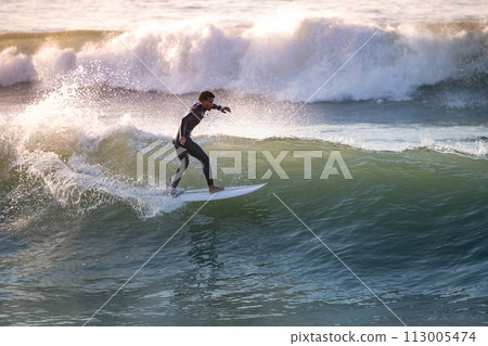 Brave teenager making tricks on the rough sea Brave teenager making tricks on the rough sea 113005474