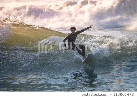 Sporty boy riding his surf board Sporty boy riding his surf board 113005478