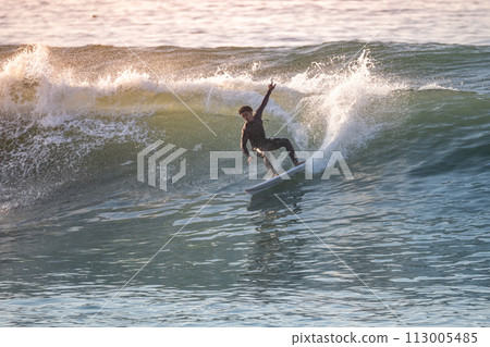 Brave teenager making tricks on the rough sea Brave teenager making tricks on the rough sea 113005485