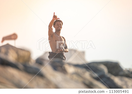 Surfer smiles and greets 113005491