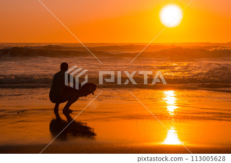 Surfer watching the waves 113005628