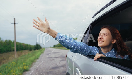 family girl car window, happy face woman smile, window seat laughter, carefree journey joy, happy road scene, road trip happiness, catching wind hand, hair blowing freedom, scenic route happiness 113005714