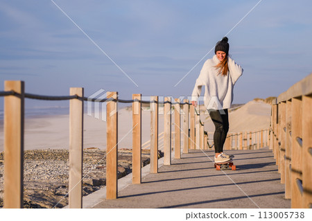 Girl riding a skateboard Girl riding a skateboard 113005738
