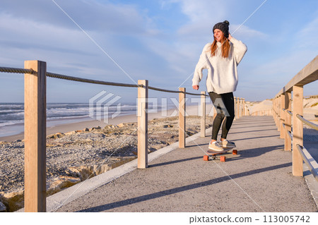 Girl riding a skateboard 113005742