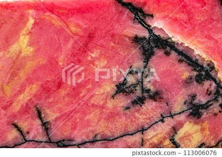 Macro stone Rhodonite mineral on white background 113006076