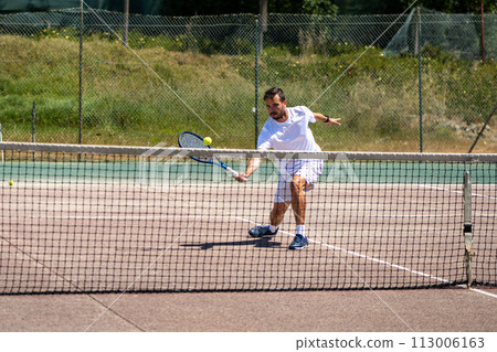 Tennis player performing a drop shot Tennis player performing a drop shot 113006163