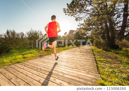Young man running 113006268